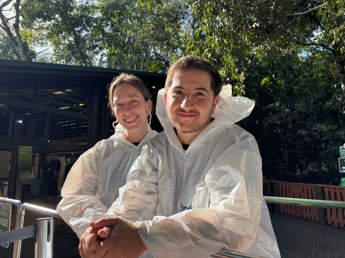 Mercedes and Michael in rain ponchos on a jungle boardwalk
